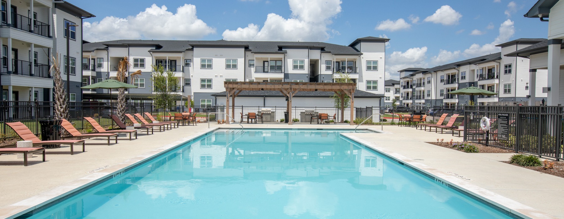 Aerial view of the pool, tennis court and clubhouse at Arbor Rose Porter apartments in New Caney.