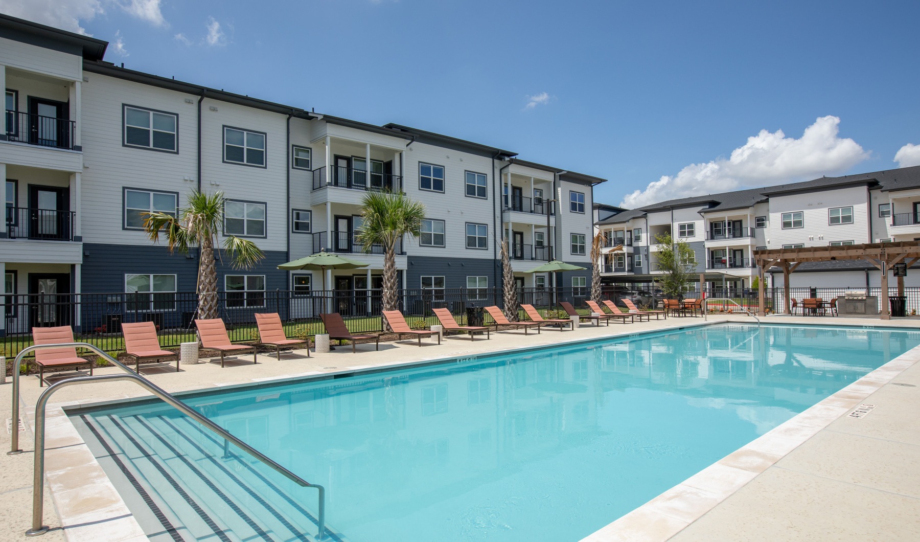a pool in a courtyard with buildings around it