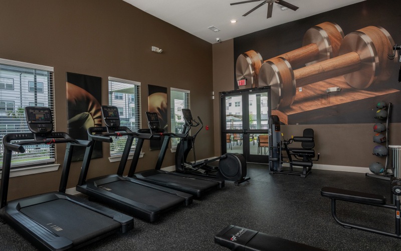 Gym with cardio and strength training equipment at Arbor Rose Porter luxury apartments near Humble, TX.