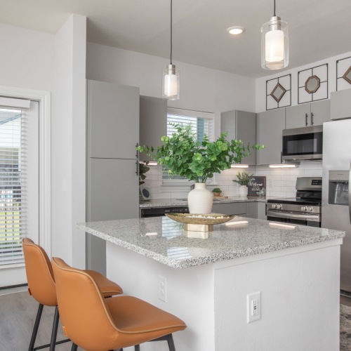 Stylish living room with table, chairs, and couch at Arbor Rose Porter apartments in montgomery county, TX.