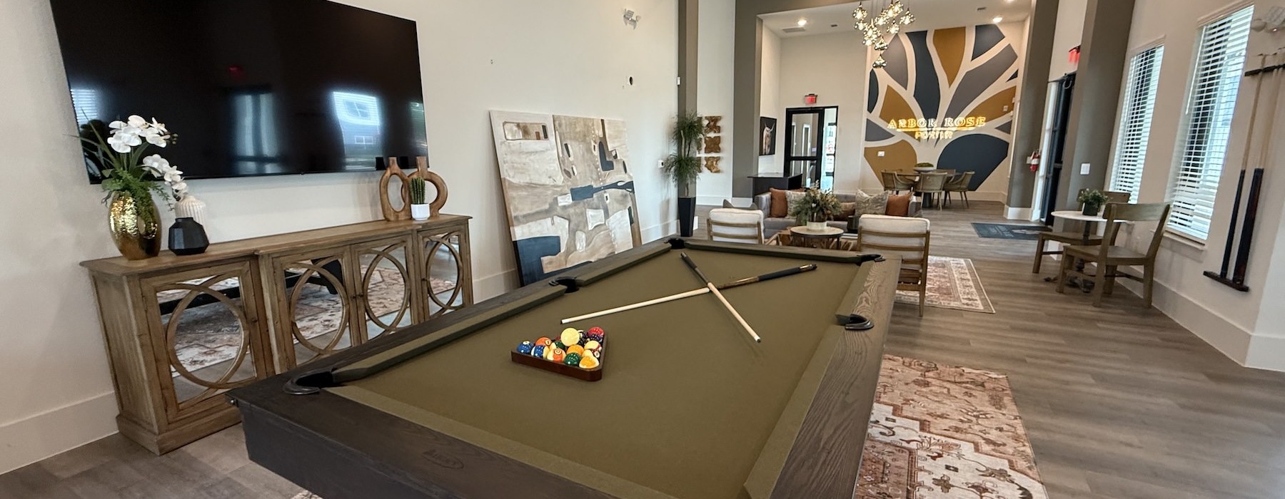a clubroom with a pool table and chairs