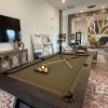 a clubroom with a pool table and a tv