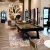 a clubroom with a pool table, chairs, tables and a rug